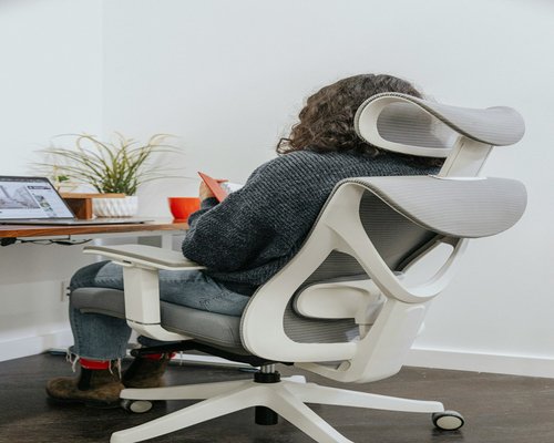 Person standing up from an office chair momentarily