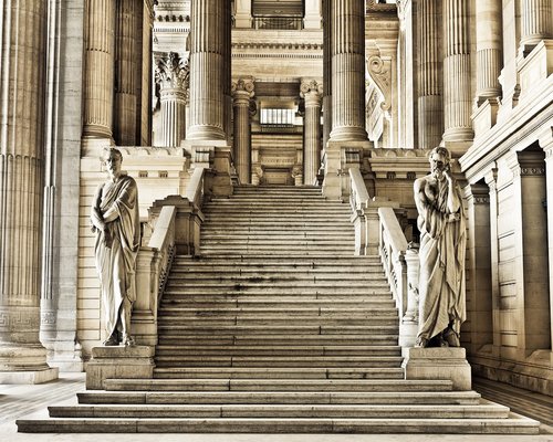 Woman walking up the stairs in the city slowly