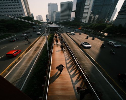 Indonesian urban commuter walking comfortably on pedestrian path