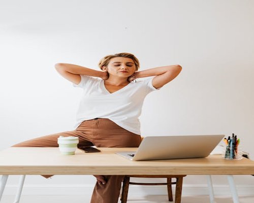 Person doing gentle stretching at an office desk