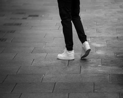 Close up of comfortable walking shoes on city pavement